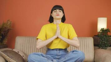 Woman meditating looking at camera. video