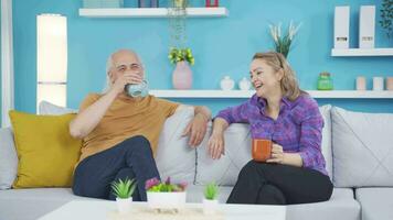 Happy couple enjoying coffee at home. video