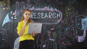 Young woman writing Research on blackboard. video