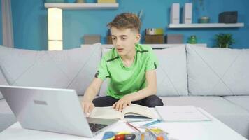 Child studying at home. Child looking at laptop and rejoicing. video