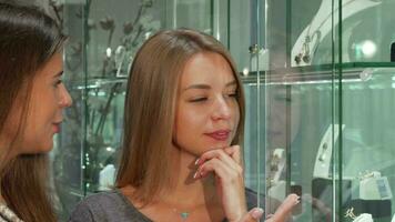 Female jeweler helping her female customer choosing jewelry to buy video