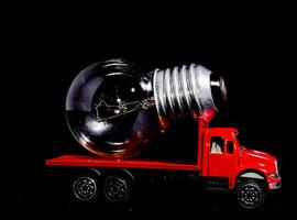 a red truck with a light bulb on top photo