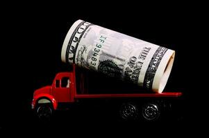 a red truck with a roll of money on top photo