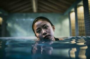 Asian woman swimming in sport indoor pool. Generate ai photo