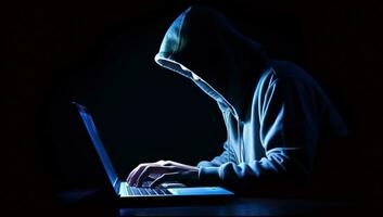 Hooded hacker stealing information from a laptop computer. AI Generated. photo