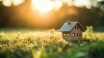 Miniature house on the grass in the park with sunlight. real estate concept. AI Generated. photo