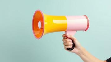 Hand Holding Megaphone Isolated on the Minimalist Background, Marketing and Sales Concept photo