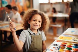 A photo of Portrait of a cute little girl with long hair in apron smiling and holding paintbrushes in her hands while standing in art class Generative AI