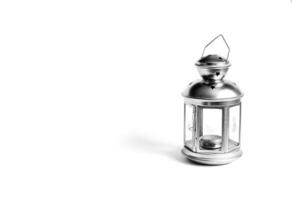 silver metal lantern on candles on white isolated background photo