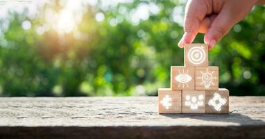 Teamwork concept, Hand holding wooden block on wooden desk with teamwork icon on virtual screen. photo