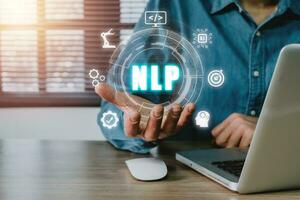 NLP natural language processing cognitive computing technology concept, Business person hand holding VR screen NLP icon on office desk, AI Artificial intelligence. photo