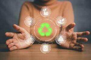 ESG concept of environmental, Green ethical business preserving resources, reducing CO2, caring for employees. Woman hand holding with VR screen ESG icon. photo