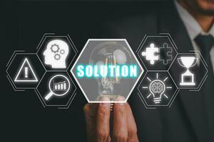 Solution concept, Businessman hand holding light bulb with solution icon on virtual screen. photo