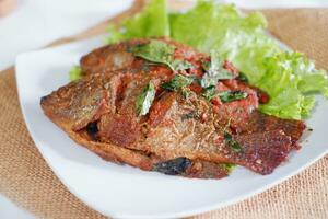 Fried mackerel fish with chili sauce photo