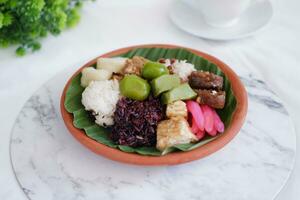 Jenang Madura is a typical Indonesian food that consists of black sticky rice, porridge marrow, jenang grendul and red pearls that were given palm sugar and coconut milk photo