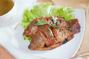 Fried mackerel fish with chili sauce photo