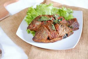 Fried mackerel fish with chili sauce photo