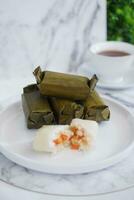 Arem-arem, a traditional food made from rice filled with vegetables, chicken, meat or tempeh wrapped in banana leaves. Arem-arem is popular as a breakfast substitute photo