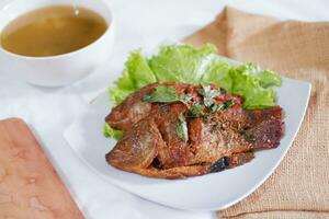 Fried mackerel fish with chili sauce photo
