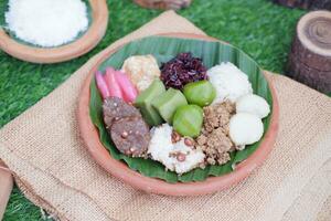 Jenang Madura is a typical Indonesian food that consists of black sticky rice, porridge marrow, jenang grendul and red pearls that were given palm sugar and coconut milk photo