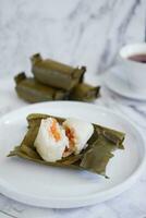 Arem-arem, a traditional food made from rice filled with vegetables, chicken, meat or tempeh wrapped in banana leaves. Arem-arem is popular as a breakfast substitute photo