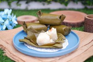 Arem-arem, a traditional food made from rice filled with vegetables, chicken, meat or tempeh wrapped in banana leaves. Arem-arem is popular as a breakfast substitute photo