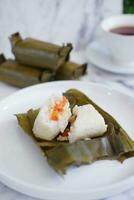 Arem-arem, a traditional food made from rice filled with vegetables, chicken, meat or tempeh wrapped in banana leaves. Arem-arem is popular as a breakfast substitute photo