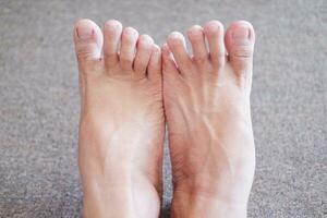 Close up of human foot on the floor, shallow depth of field photo