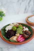 Jenang Madura is a typical Indonesian food that consists of black sticky rice, porridge marrow, jenang grendul and red pearls that were given palm sugar and coconut milk photo