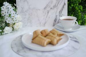 Lepet or Leupeut is a type of snack made from glutinous rice mixed with peanuts, cooked in coconut milk, then wrapped in coconut leaves. Close up view photo