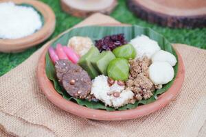 Jenang Madura is a typical Indonesian food that consists of black sticky rice, porridge marrow, jenang grendul and red pearls that were given palm sugar and coconut milk photo