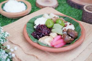 Jenang Madura is a typical Indonesian food that consists of black sticky rice, porridge marrow, jenang grendul and red pearls that were given palm sugar and coconut milk photo