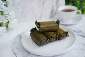 Arem-arem, a traditional food made from rice filled with vegetables, chicken, meat or tempeh wrapped in banana leaves. Arem-arem is popular as a breakfast substitute photo