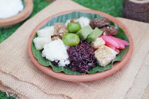 Jenang Madura is a typical Indonesian food that consists of black sticky rice, porridge marrow, jenang grendul and red pearls that were given palm sugar and coconut milk photo