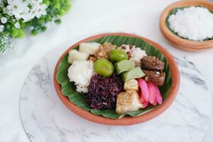 Jenang Madura is a typical Indonesian food that consists of black sticky rice, porridge marrow, jenang grendul and red pearls that were given palm sugar and coconut milk photo