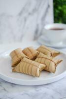 Lepet or Leupeut is a type of snack made from glutinous rice mixed with peanuts, cooked in coconut milk, then wrapped in coconut leaves. Close up view photo