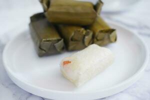Arem-arem, a traditional food made from rice filled with vegetables, chicken, meat or tempeh wrapped in banana leaves. Arem-arem is popular as a breakfast substitute photo