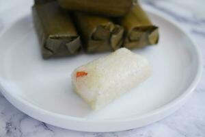Arem-arem, a traditional food made from rice filled with vegetables, chicken, meat or tempeh wrapped in banana leaves. Arem-arem is popular as a breakfast substitute photo