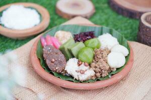 Jenang Madura is a typical Indonesian food that consists of black sticky rice, porridge marrow, jenang grendul and red pearls that were given palm sugar and coconut milk photo