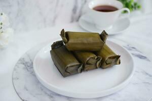 Arem-arem, a traditional food made from rice filled with vegetables, chicken, meat or tempeh wrapped in banana leaves. Arem-arem is popular as a breakfast substitute photo