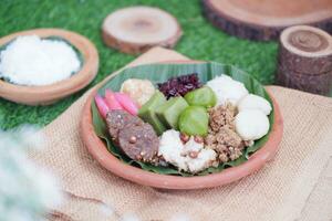 Jenang Madura is a typical Indonesian food that consists of black sticky rice, porridge marrow, jenang grendul and red pearls that were given palm sugar and coconut milk photo