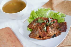 Fried mackerel fish with chili sauce photo