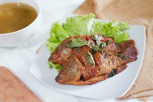 Fried mackerel fish with chili sauce photo