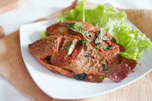 Fried mackerel fish with chili sauce photo