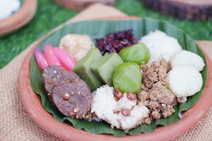 Jenang Madura is a typical Indonesian food that consists of black sticky rice, porridge marrow, jenang grendul and red pearls that were given palm sugar and coconut milk photo