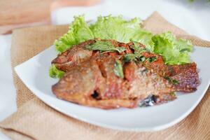 Fried mackerel fish with chili sauce photo