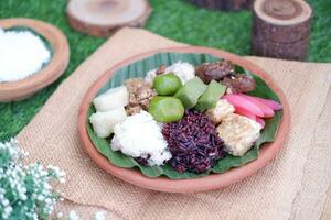 Jenang Madura is a typical Indonesian food that consists of black sticky rice, porridge marrow, jenang grendul and red pearls that were given palm sugar and coconut milk photo