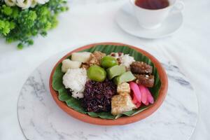 Jenang Madura is a typical Indonesian food that consists of black sticky rice, porridge marrow, jenang grendul and red pearls that were given palm sugar and coconut milk photo