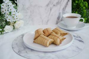 Lepet or Leupeut is a type of snack made from glutinous rice mixed with peanuts, cooked in coconut milk, then wrapped in coconut leaves. Close up view photo