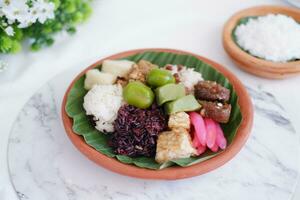 Jenang Madura is a typical Indonesian food that consists of black sticky rice, porridge marrow, jenang grendul and red pearls that were given palm sugar and coconut milk photo